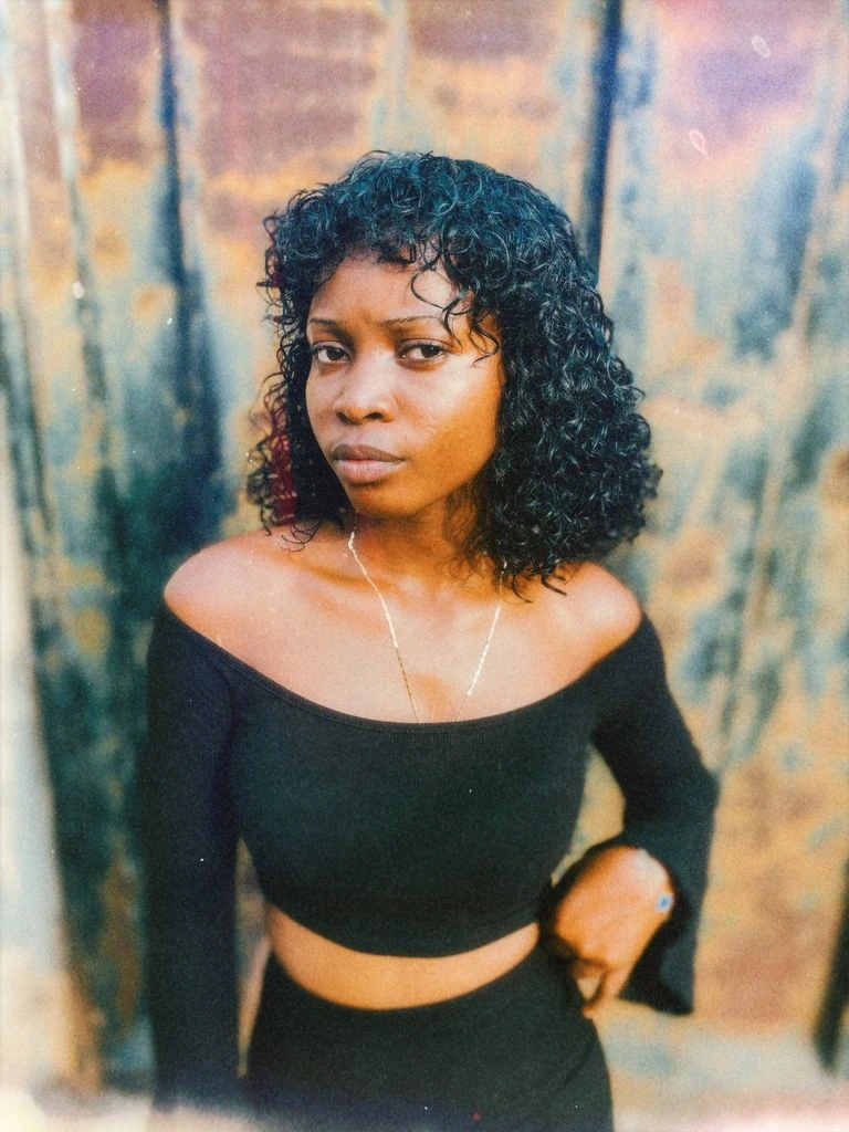 Portrait of curator Mara Osei at golden hour.